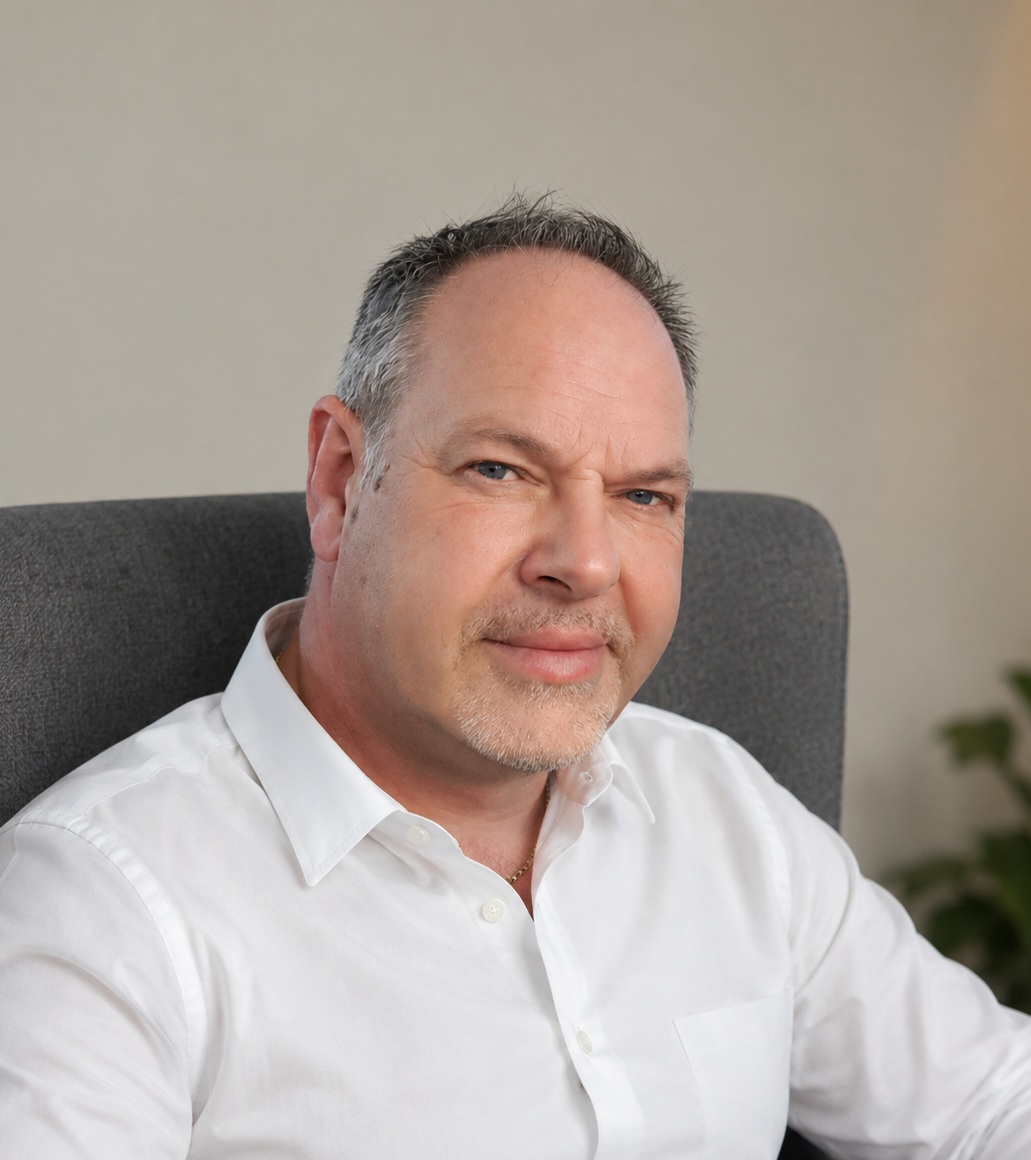 Carl Lingwood, counsellor, seated in his therapy room